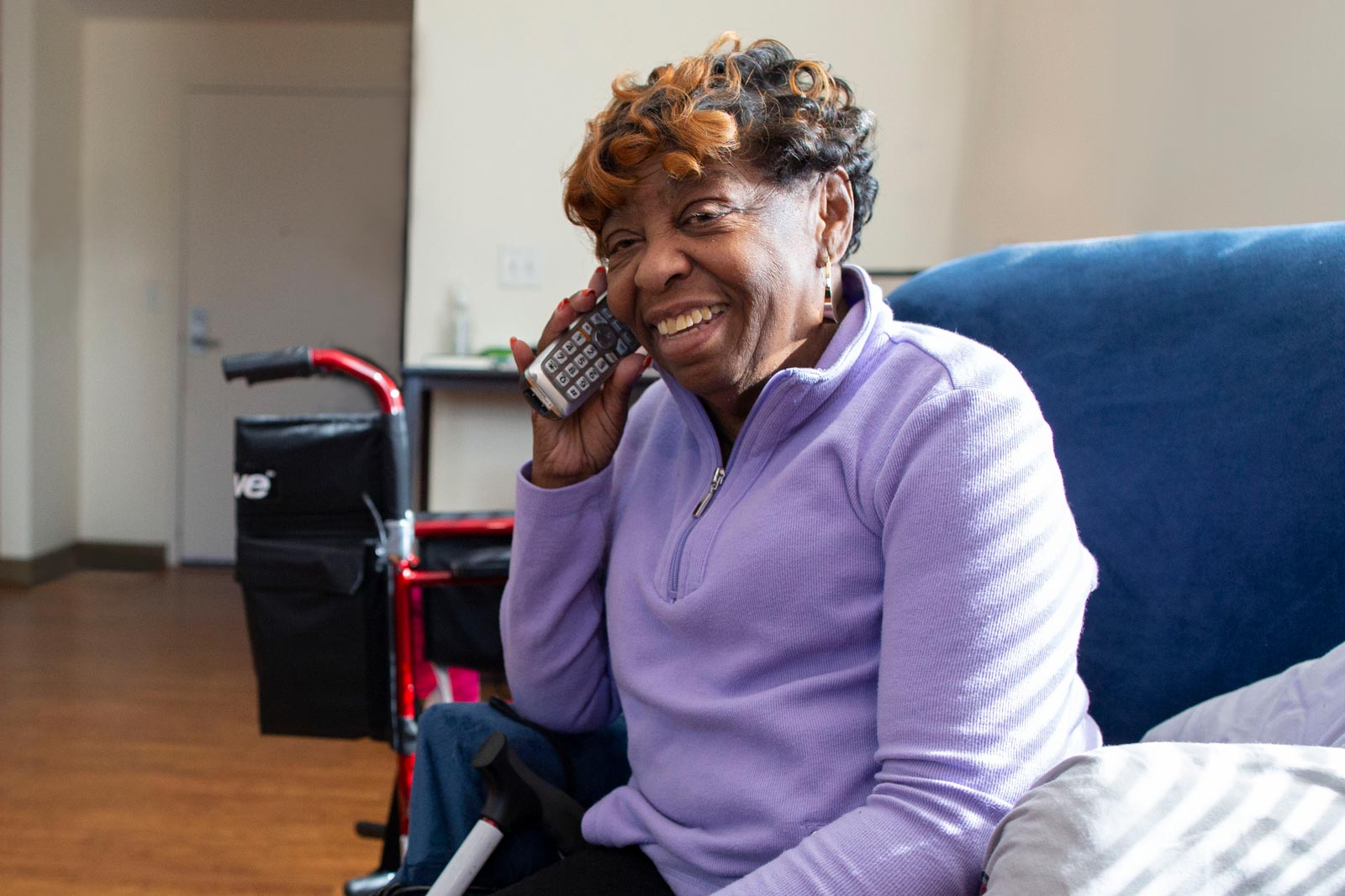 Senior woman with chronic health needs happily calling to become CCA member