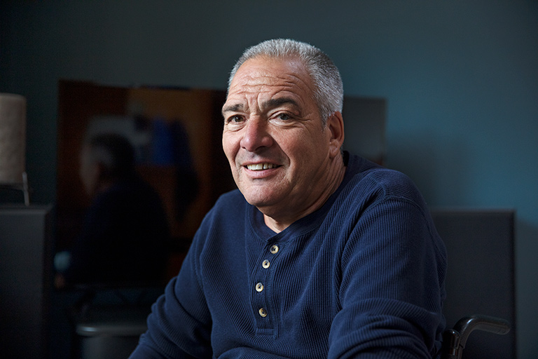 CCA One Care member smiling in his living room