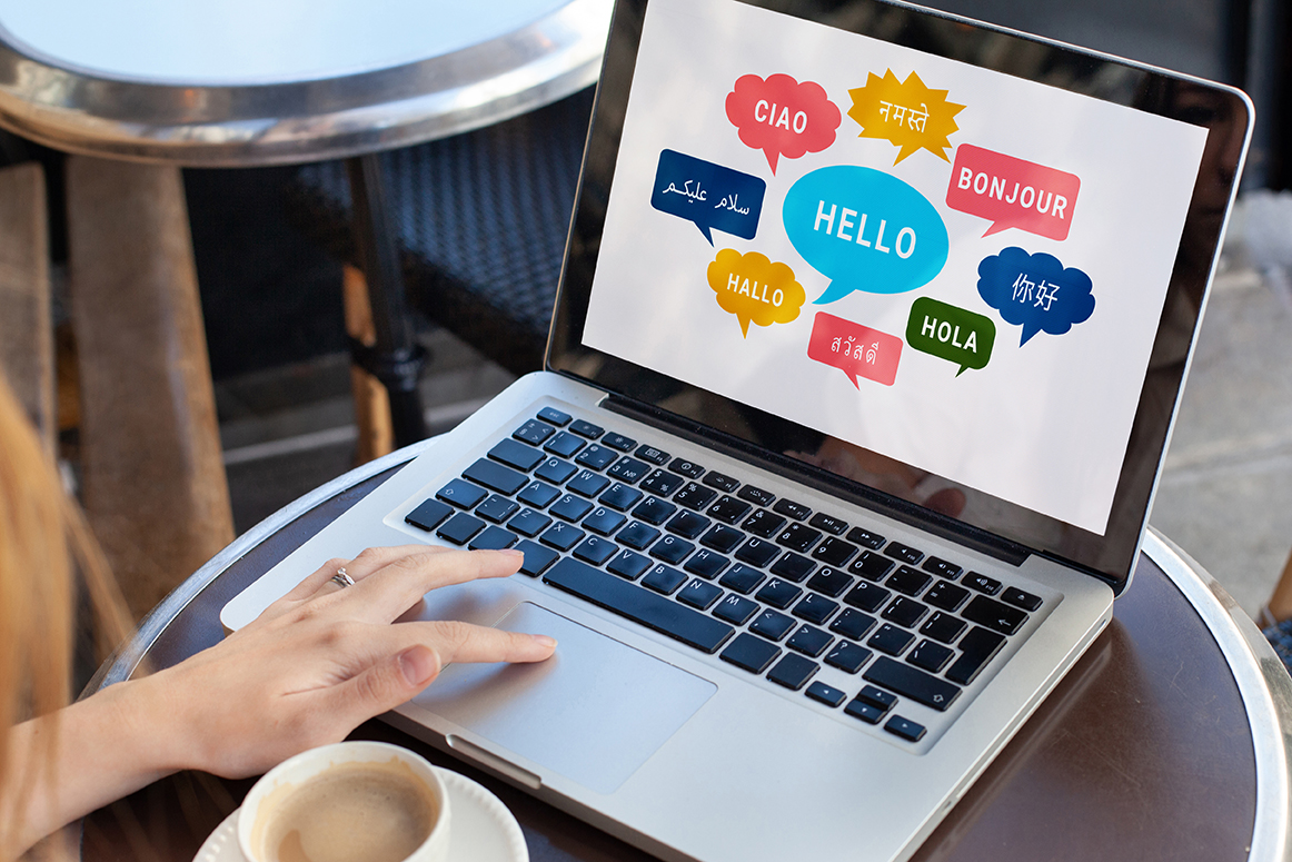 laptop showing talk bubbles with multiple languages