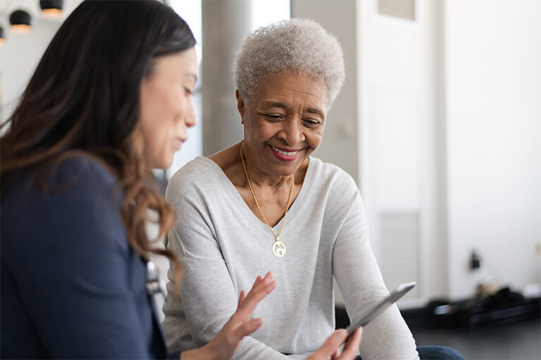 Older woman receiving care from her CCA care partner in her living room