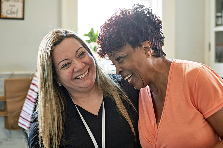 woman and care partner laughing