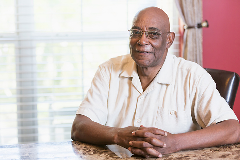 Senior man seated at his kitchen table