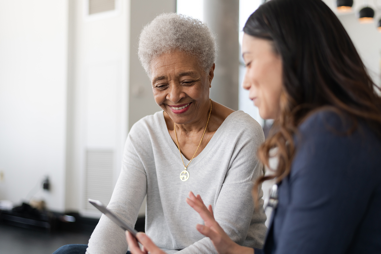 Senior woman smiling and talking with another woman