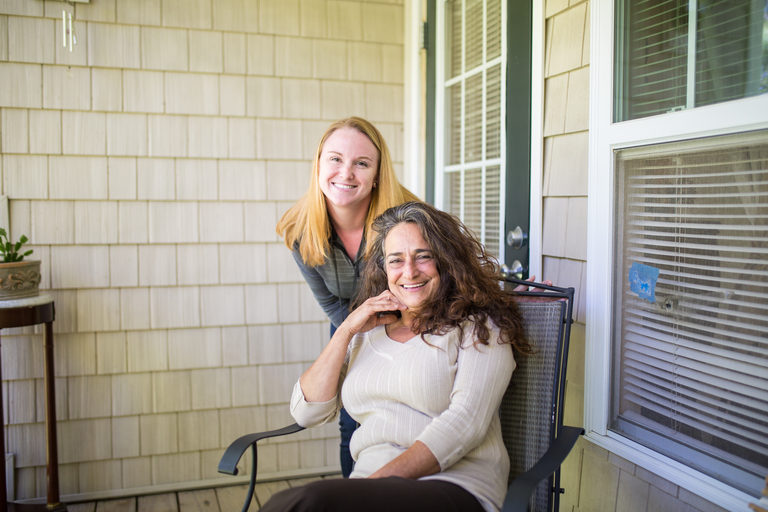 CCA One Care member Lyne sits outside her home with her care partner