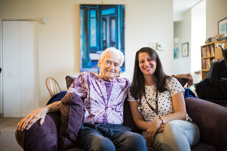 Older man seated on couch with his CCA care partner