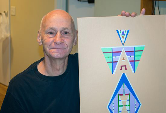 CCA SCO member Jim holding a geometric painting