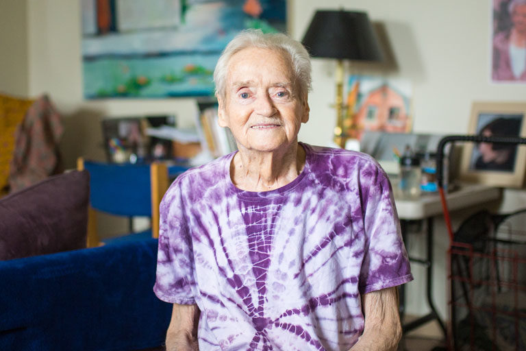 Male Senior Care Options member Hal smiling while seated at home