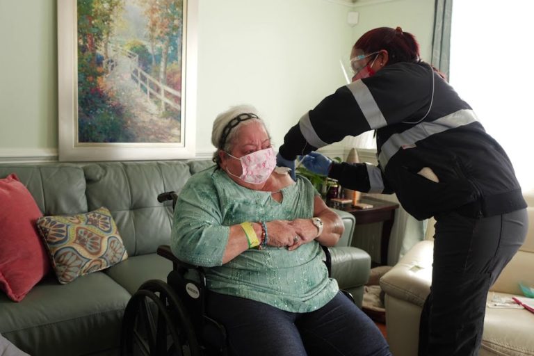 Sign Up for the Mass COVID-19 Homebound Vaccination Program CCA employee administers vaccine to senior woman in her home