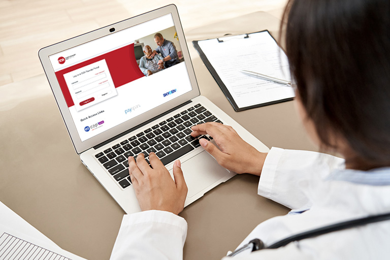Female doctor logging in to CCA Provider Portal on a laptop