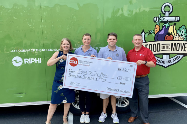 Commonwealth Care Alliance® Commits $60,000 to Combat Food Insecurity in Rhode Island Image of a CCA employee giving a donation check for $25,000 to employees of Food on the Move in Rhode Island.