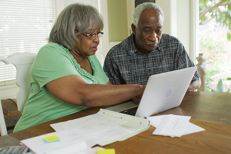 Older married couple looking at a laptop