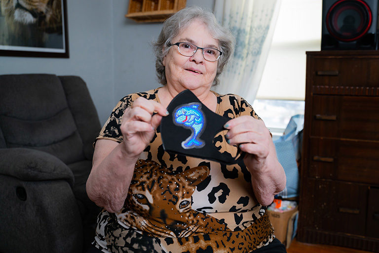 CCA member Cynthia in her home showing her diamond art