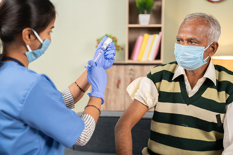 A nurse giving a patient the flu shot