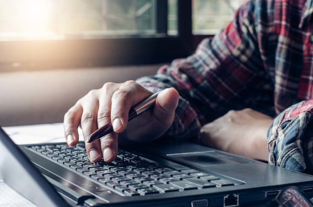 User finding information on his laptop