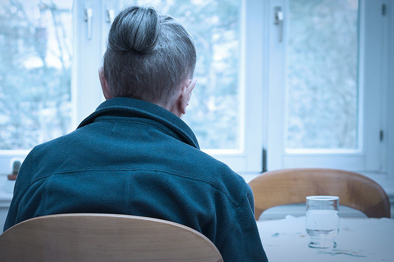 A lonely woman sitting at a table