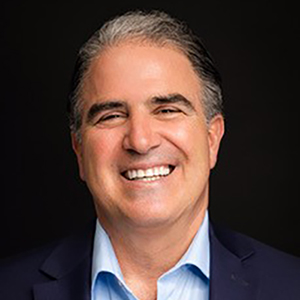 Frank Scalise, smiling man in a blue shirt.