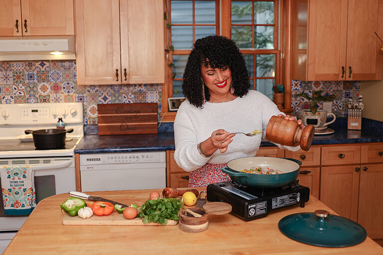 Image of Omi Hopper cooking a meal in her kitchen