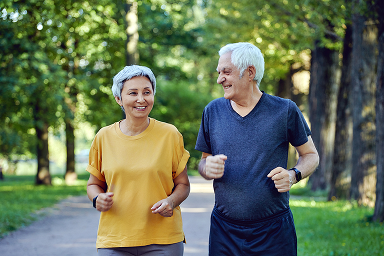 Older adults running in the park. 