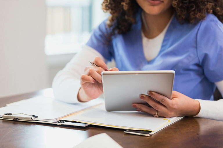 2025 Provider Manual and Prior Authorization list now available Nurse reviewing information on an ipad