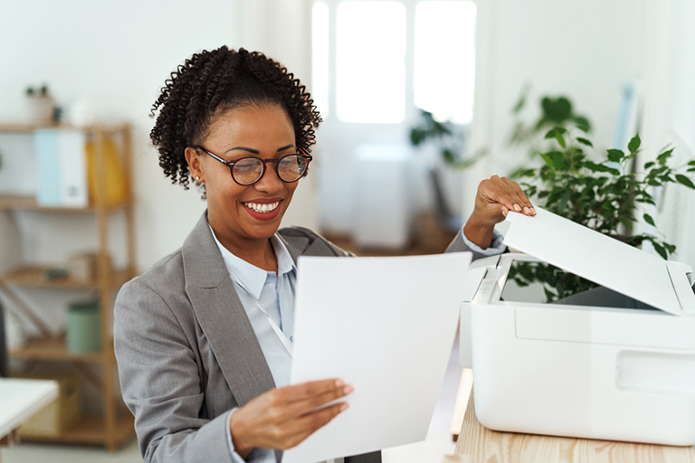 Effective February 3, 2025: New fax number for Durable Medical Equipment referral submissions Woman with paper in her hands about to fax some documentation.