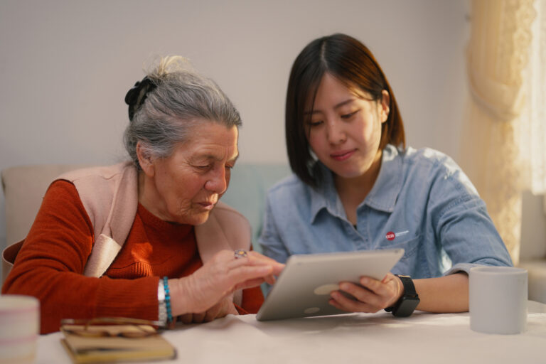 Commonwealth Care Alliance Senior Care Options Plan Achieves 4 Star Quality Rating from CMS CCA care partner sitting at a table with a CCA member reviewing the members' care plan
